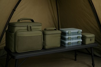 Tackle boxes and rigs aligned in a neat row beside a small table